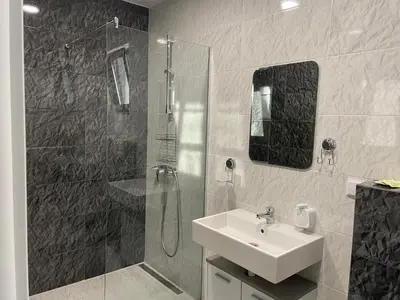a bathroom with a sink and a shower and a sink at Apartment Bela in Obzor
