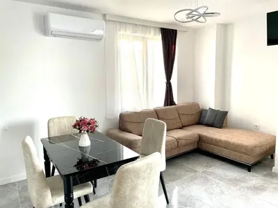 a living room with a table and a couch at Apartment Bela in Obzor