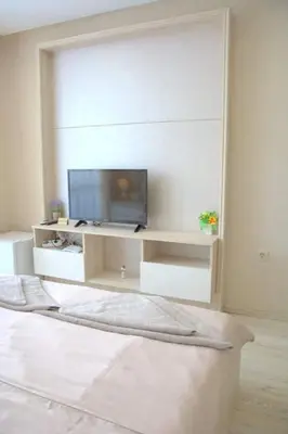 a white room with a tv and a bed at PARADISO B 410 Studio with SEA VIEW in Nesebar