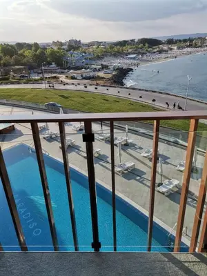 a balcony with a view of the beach and water at PARADISO B 410 Studio with SEA VIEW in Nesebar