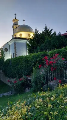 a church with a cross on top of a building at Ela, Kedar 5 in Sveti Vlas