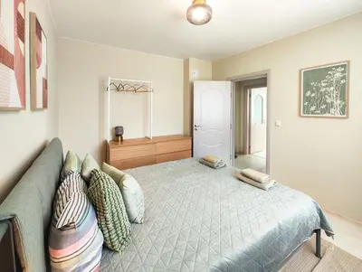 a bedroom with a bed with pillows on it at Marina's Flat in Varna City