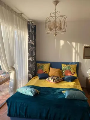 a bedroom with a large bed with pillows on it at Kasandra Apart Hotel in Sunny Beach