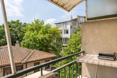 a balcony with a view of a building at Aristocratic to the Sea Garden in Varna City