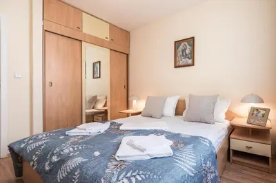 a bedroom with a bed with towels on it at Aristocratic to the Sea Garden in Varna City