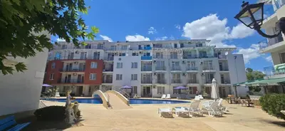 a large building with a swimming pool in front of a building at New 3Room Maisonette Apartment in Sunny Day 3 Sunny Beach in Sunny Beach