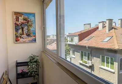 a room with a window with a view of a building at Stylish Apartment - the Heart of Central Varna by Flat Manаger in Varna City