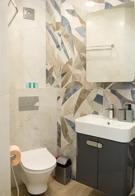 a bathroom with a white sink and a toilet at Stylish Apartment - the Heart of Central Varna by Flat Manаger in Varna City