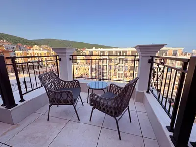 a balcony with three chairs and a table on it at Boutique & Design Appartement - Emperium 1 in Sveti Vlas
