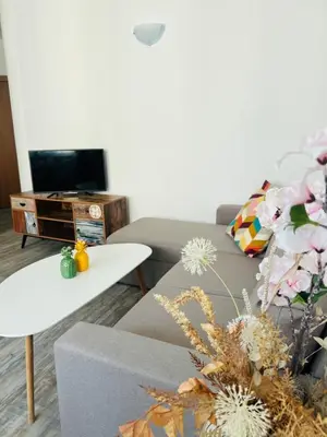 a living room with a couch and a table at Green Paradise apartments in Sveti Vlas