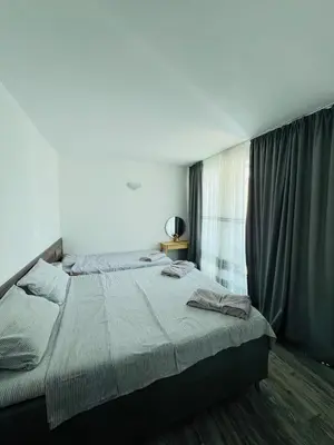 a bedroom with a large bed in front of a window at Green Paradise apartments in Sveti Vlas