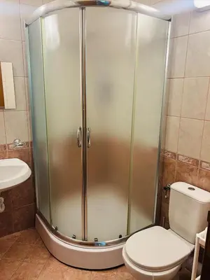 a shower stall in a bathroom with a toilet at Green Paradise apartments in Sveti Vlas