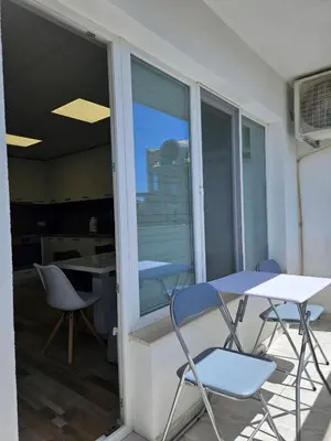 two chairs and a table on a balcony at Central Flat, Close to the beach in Burgas City