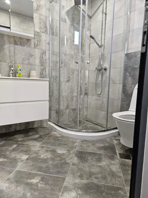 a bathroom with a shower and a toilet and a sink at Central Flat, Close to the beach in Burgas City
