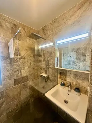 a bathroom with a sink and a glass shower at Complex Gallery Saint Thomas in Sozopol