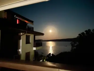 a house with a view of a lake at night at Complex Gallery Saint Thomas in Sozopol