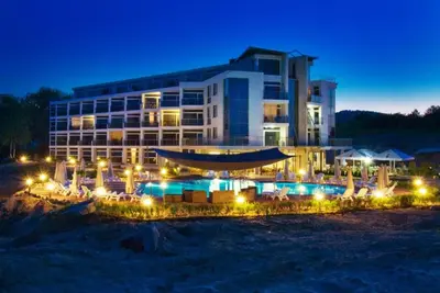 a hotel with a swimming pool at night at Apartment Zornitsa I Panoramic Sea View in Sozopol