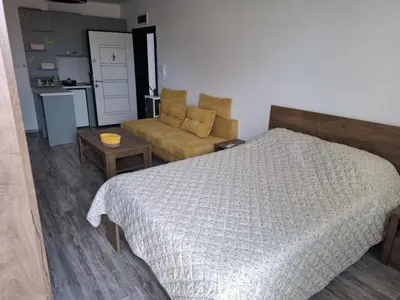 a bedroom with a bed and a couch at РАВДА Лазур Аурелия in Ravda