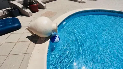 a large swimming pool with a ball in the water at ATOS 507 Studio Sunny Beach in Sunny Beach