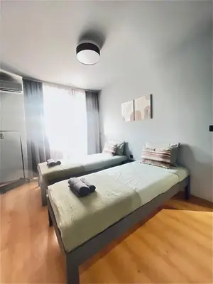 a bedroom with two beds and a window at Heart of City, Steps to Beach in Burgas City