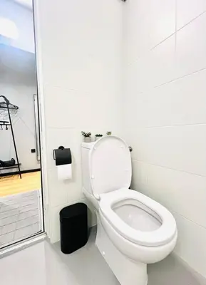 a bathroom with a toilet and a walk in shower at Heart of City, Steps to Beach in Burgas City