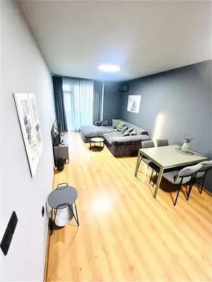 a living room with a couch and a table at Heart of City, Steps to Beach in Burgas City