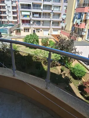 a balcony with a view of a building at Dobi Apartments in Pomorie