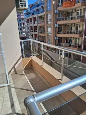 a balcony of a building with buildings in the background at Dobi Apartments in Pomorie