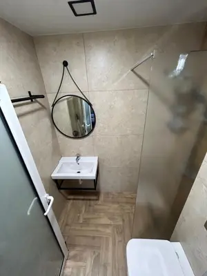 a bathroom with a sink and a mirror at Апартаменти Лилия 2 in Primorsko