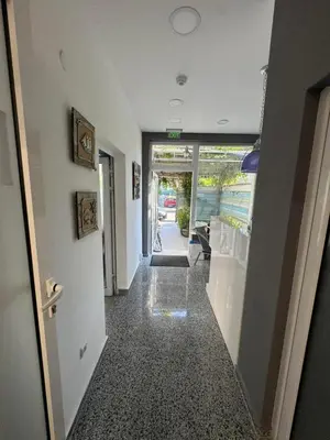 an empty hallway with a hallway leading to a room at Апартаменти Лилия 2 in Primorsko