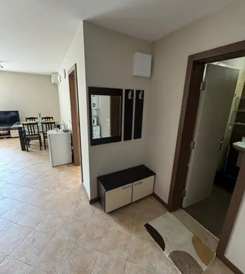 a living room with a table and a mirror at Casa Oasis Lozenets in Lozenets