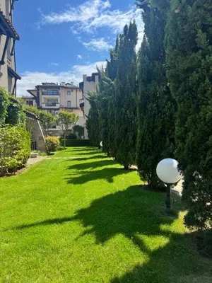 a green yard with trees and a street light at Casa Oasis Lozenets in Lozenets