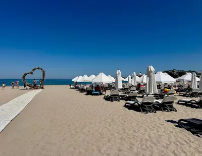 a row of chairs and umbrellas on a beach at Casa Oasis Lozenets in Lozenets