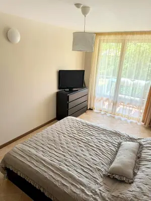 a bedroom with a bed and a flat screen tv at Casa Oasis Lozenets in Lozenets