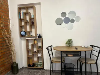 a table and chairs in a room with a wall at 3D Studio in Varna City
