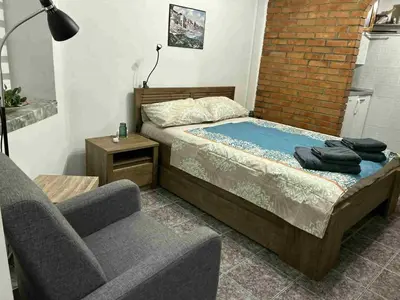 a bedroom with a bed and a couch and a chair at 3D Studio in Varna City
