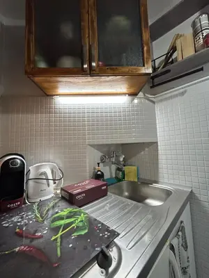 a kitchen with a sink and a counter top with a cutting board at 3D Studio in Varna City