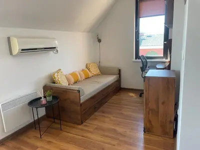 a small living room with a couch and a window at Raduga SP apartments St Vlas in Sunny Beach