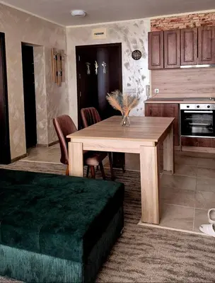 a kitchen with a wooden table and a dining room at White Cliffs первая линия in Byala