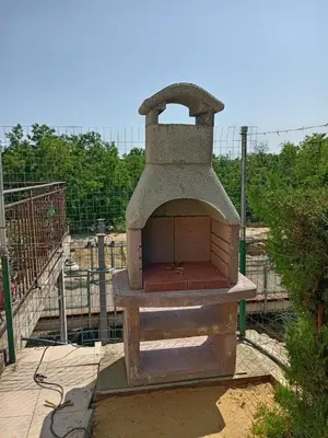 an outdoor oven sitting on top of a patio at Апартаменты за гости Гавань in Byala