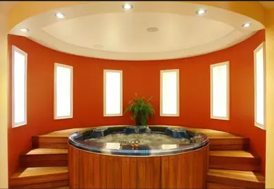 a hot tub in a room with orange walls at Vineyards Resort, Aheloy - Studio 32 in Pomorie