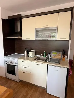 a kitchen with white cabinets and a sink at Vineyards Resort, Aheloy - Studio 32 in Pomorie