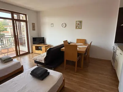 a living room with a table and a dining room at Vineyards Resort, Aheloy - Studio 32 in Pomorie
