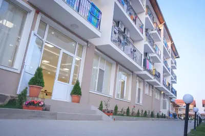 a building with stairs and potted plants on the side at ВС Морски дюни in Shkorpilovtsi