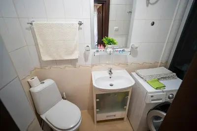a small bathroom with a toilet and a sink at The Family Courtyard - Very LARGE 2BD Apartment by Flat Manаger in Ravda