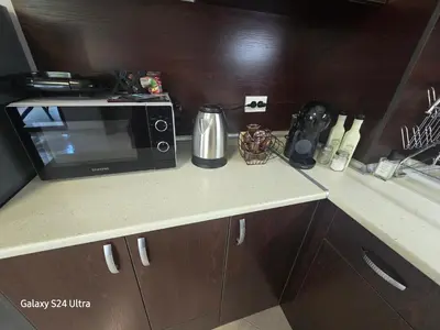 a kitchen counter with a microwave on top of it at Elia Relax & Lux in Aheloy
