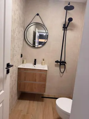a bathroom with a sink and a mirror on the wall at South Beach Apartment Primorsko 2 in Primorsko