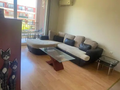 a living room with a couch and a table at Pool View, 2 Bedroom Apartment in Sunny Beach