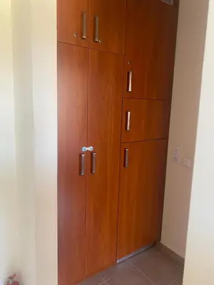 a large wooden cabinet in a room at Pool View, 2 Bedroom Apartment in Sunny Beach