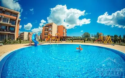 a child in a swimming pool at a resort at Pool View, 2 Bedroom Apartment in Sunny Beach